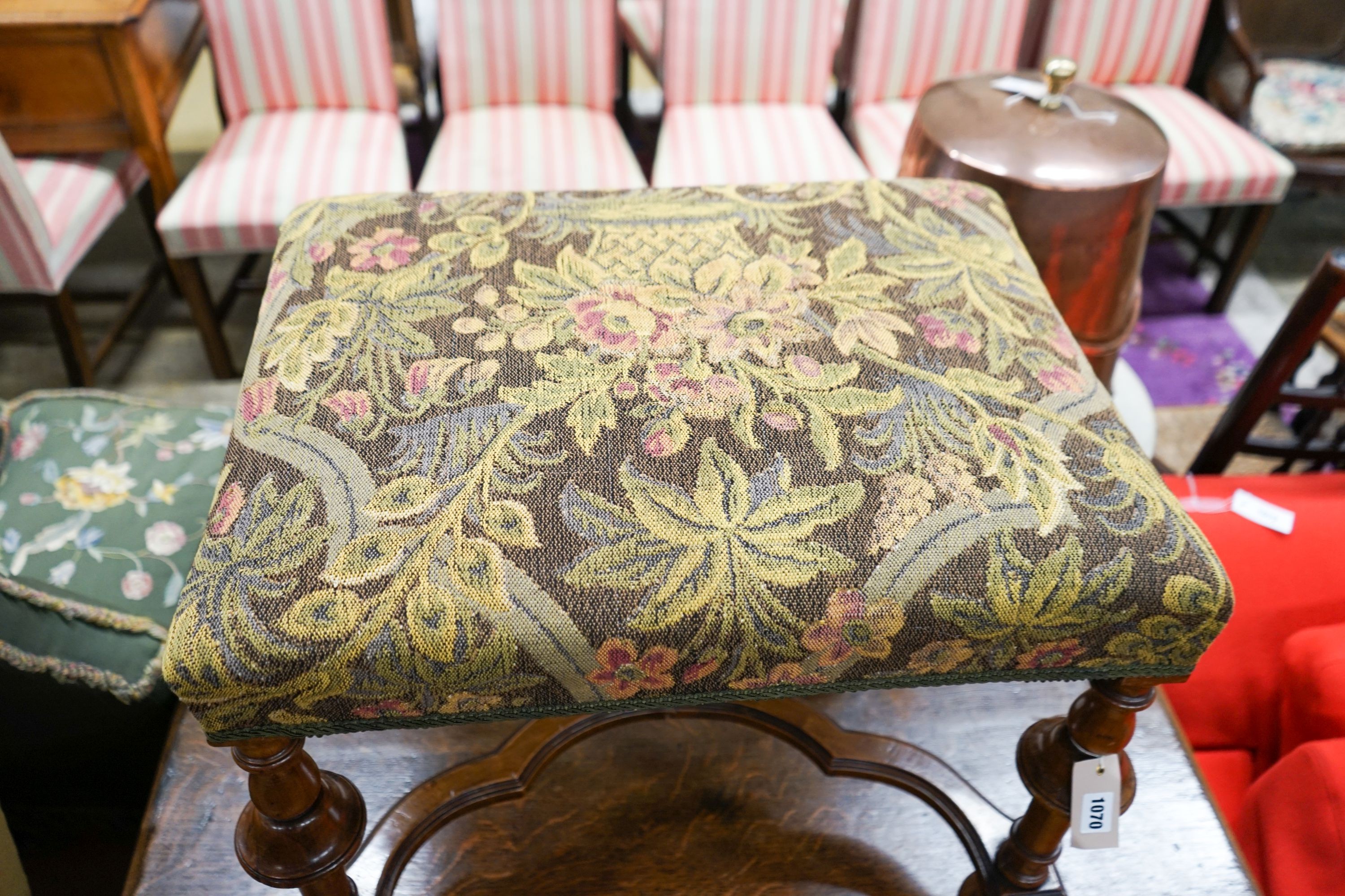 A William and Mary style walnut stool, having embroidery-covered seat on turned supports with cross stretcher and ball feet, length 63cm, depth 49cm, height 54cm